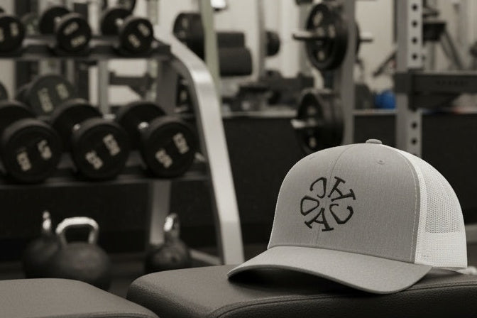 Gray cap with a logo on a gym bench